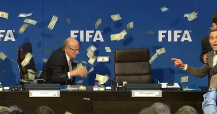 Comedian interrupts FIFA press conference by throwing money at Sepp Blatter