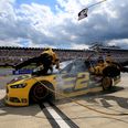 Watch as NASCAR driver crashes into his pit crew (Video)