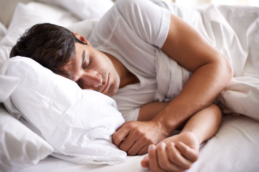 Shot of a young man sleeping in bed