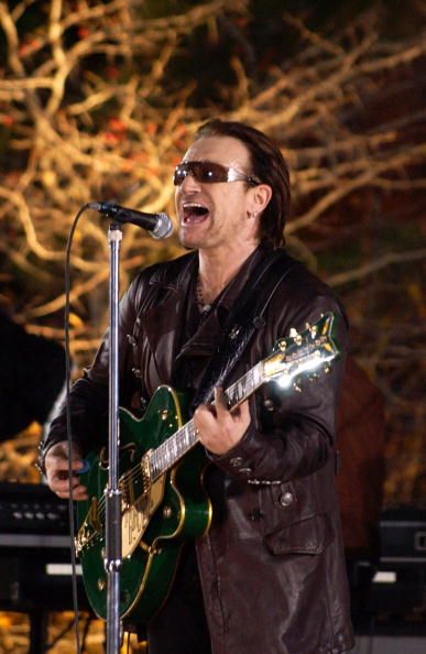 NEW YORK - NOVEMBER 22: Singer Bono performs with the rock group U2 during the taping of a music video at Empire-Fulton Ferry State Park November 22, 2004 in the Brooklyn borough of New York City. (Photo by Bryan Bedder/Getty Images)