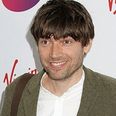 Blur’s Alex James proves all is forgiven by playing Oasis’ ‘Wonderwall’ (Video)