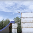 BMX junkie creates huge skatepark out of shipping containers…then backflips off the top (Video)