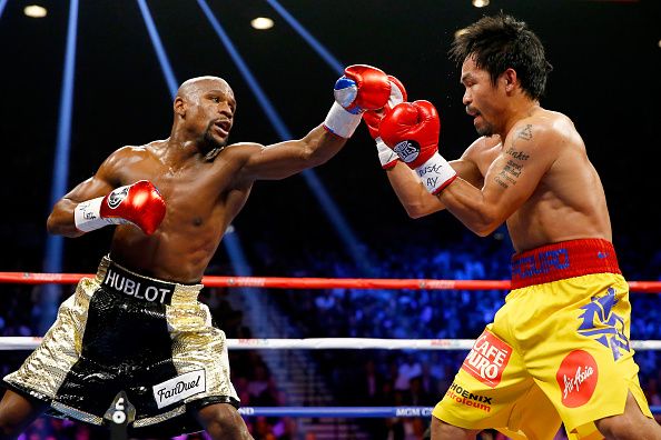 Floyd Mayweather Jr. throws a right at Manny Pacquiao during their welterweight unification championship bout on May 2, 2015 at MGM Grand Garden Arena in Las Vegas, Nevada.