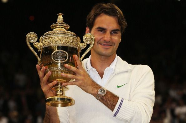 LONDON, ENGLAND - JULY 08: Roger Federer of Switzerland holds up the winner's trophy after winning his Gentlemen's Singles final match against Andy Murray of Great Britain on day thirteen of the Wimbledon Lawn Tennis Championships at the All England Lawn Tennis and Croquet Club on July 8, 2012 in London, England. (Photo by Clive Brunskill/Getty Images)
