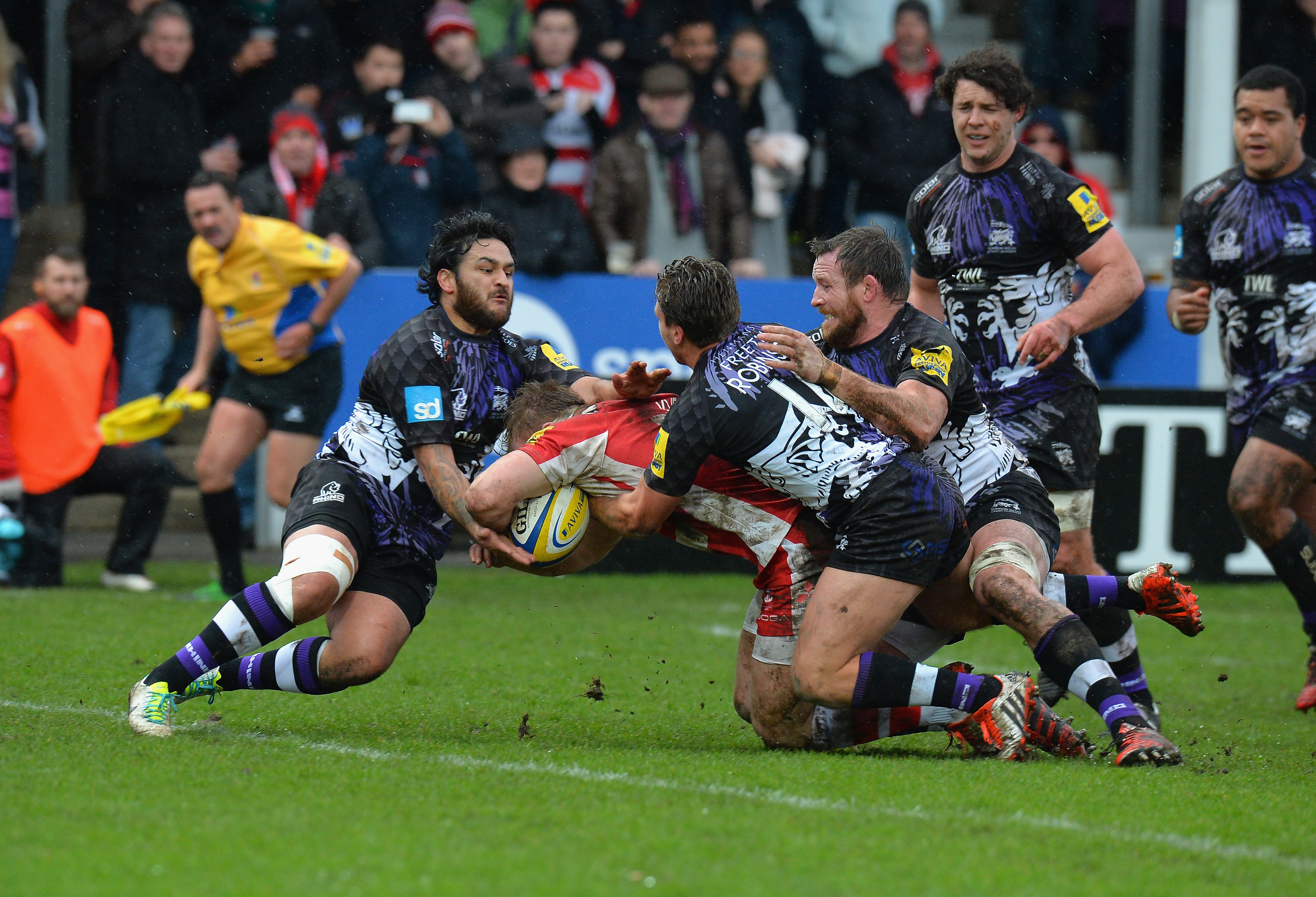 xxxx of Gloucester Rugby is tackled by xxxx of London Welsh during the Aviva Premiership match between Gloucester Rugby and London Welsh at Kingsholm Stadium on February 21, 2015 in Gloucester, England.