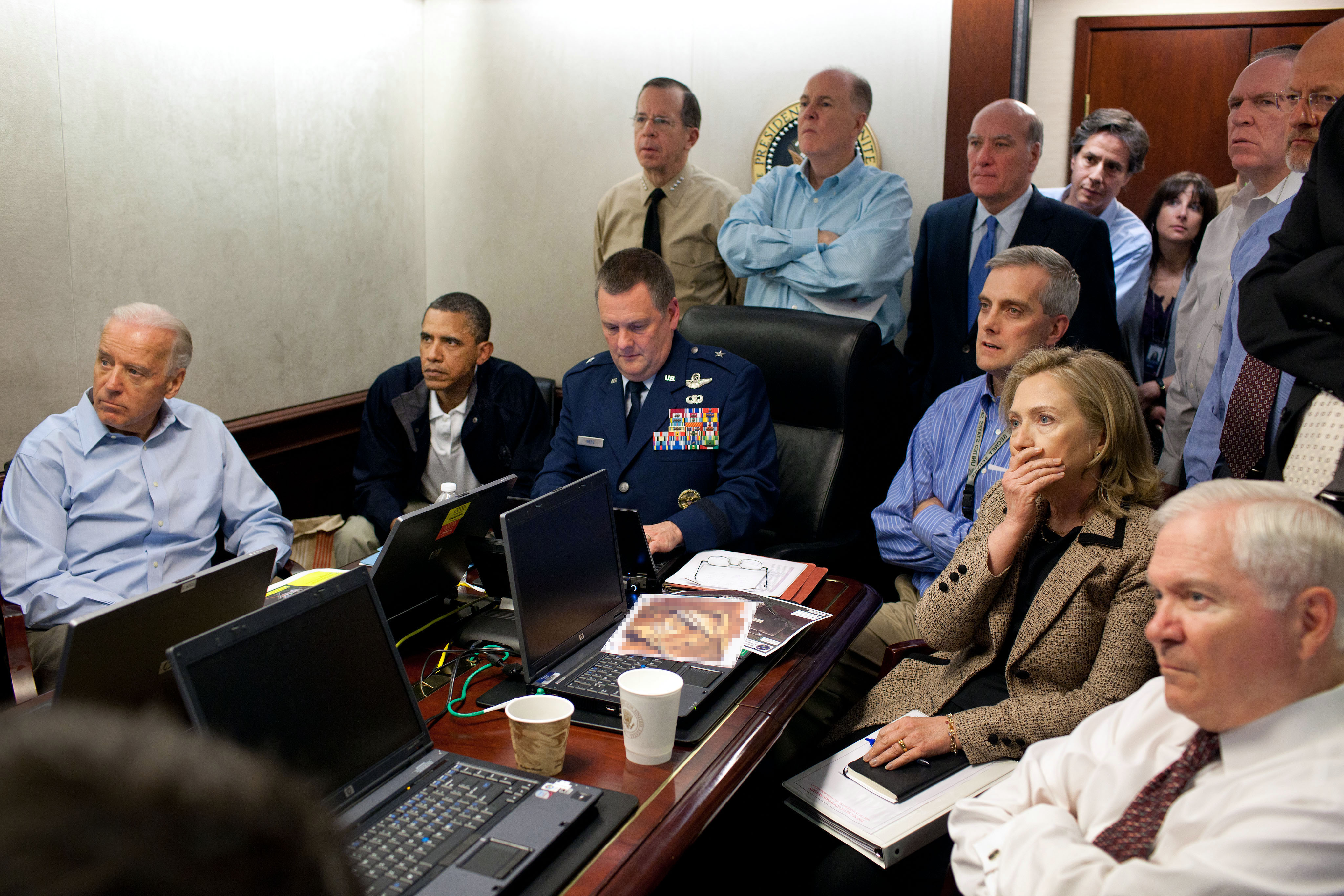 President Barack Obama and Vice President Joe Biden, along with with members of the national security team, receive an update on the mission against Osama bin Laden in the Situation Room of the White House, May 1, 2011. Please note: a classified document seen in this photograph has been obscured.<br /> <h6>(Official White House Photo by Pete Souza) This official White House photograph is being made available only for publication by news organizations and/or for personal use printing by the subject(s) of the photograph. The photograph may not be manipulated in any way and may not be used in commercial or political materials, advertisements, emails, products, promotions that in any way suggests approval or endorsement of the President, the First Family, or the White House.