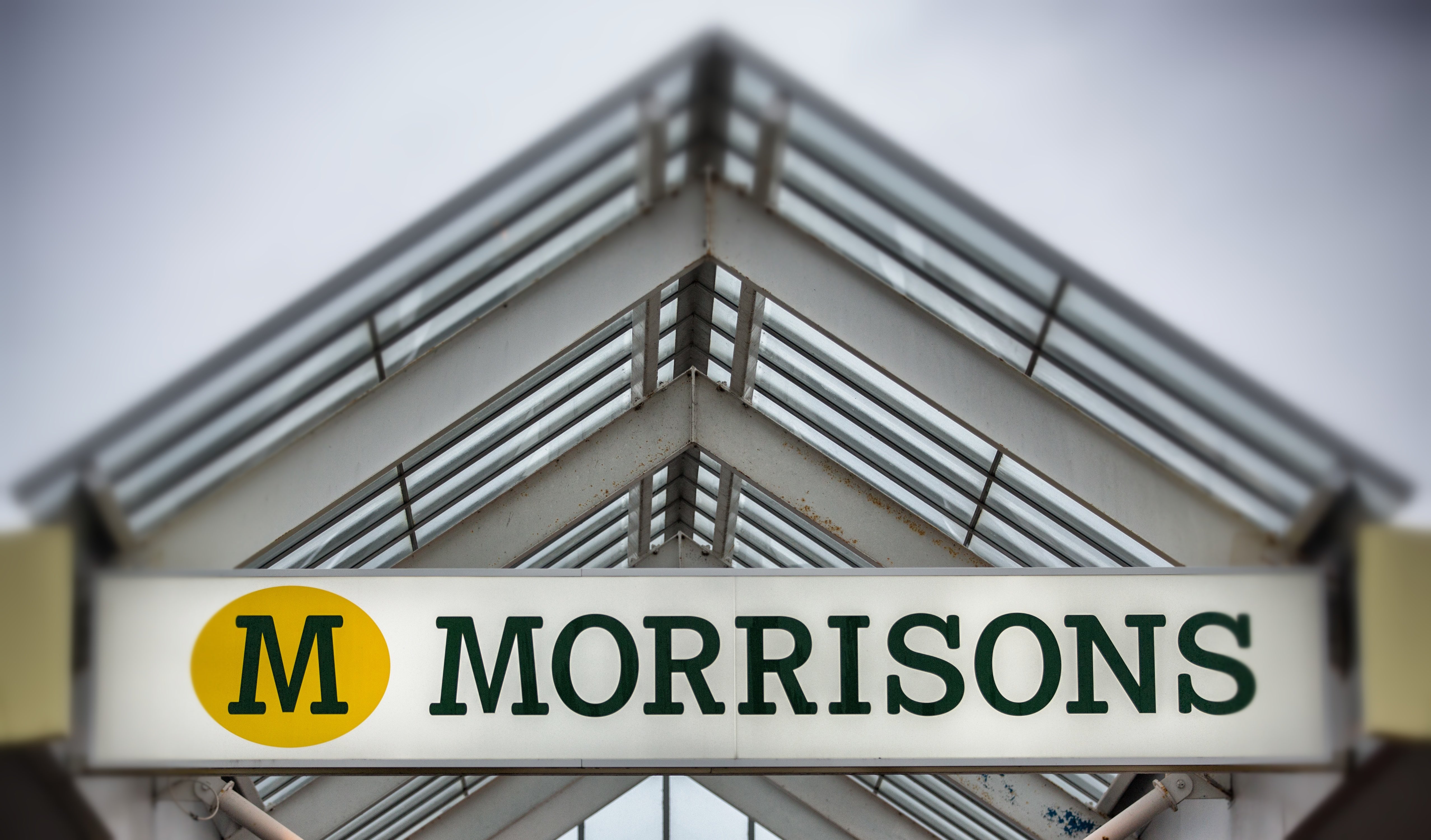 BRISTOL, ENGLAND - NOVEMBER 18: (EDITORS NOTE: This image was created using digital filters) The Morrisons sign is displayed outside a branch of the supermarket on November 18, 2015 in Bristol, England. As the crucial Christmas retail period approaches, all the major supermarkets are becoming increasingly competitive to retain and increase their share of the market. (Photo by Matt Cardy/Getty Images)