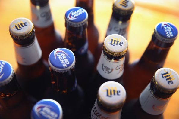 CHICAGO, IL - SEPTEMBER 15: In this photo illustration, bottles of Miller Lite and Bud Light beer that are products of SABMiller and Anheuser-Busch InBev (respectively) are shown on September 15, 2014 in Chicago. Illinois. Shares of SABMiller have surged to an all-time high today on speculation of a takeover bid by Anheuser-Busch InBev, the world's largest brewer. (Photo Illustration by Scott Olson/Getty Images)