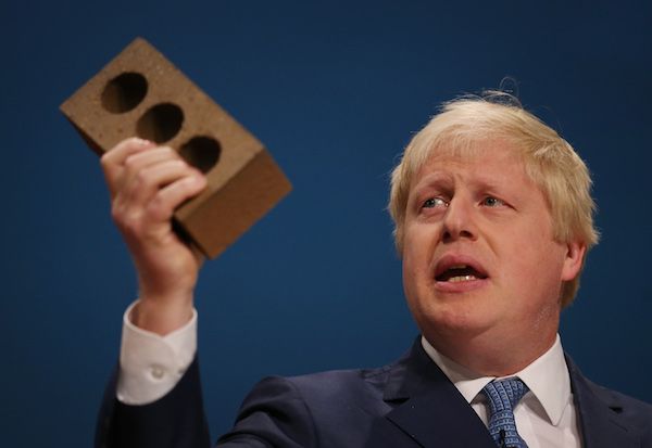 BIRMINGHAM, ENGLAND - SEPTEMBER 30: Mayor of London Boris Johnson holds a house brick aloft as he addresses the Conservative party conference on September 30, 2014 in Birmingham, England. The third day of conference will see speeches on home affairs and justice. (Photo by Peter Macdiarmid/Getty Images)