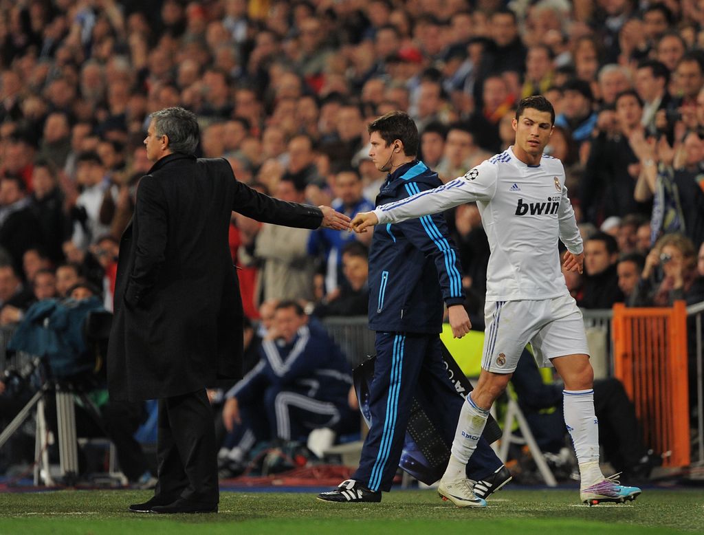 MADRID, SPAIN - MARCH 16: Cristiano Ronaldo (R) of Real Madrid shakes hands with head coach Jose Mourinho after being substituted during the UEFA Champions League round of 16 second leg match between Real Madrid and Lyon at Estadio Santiago Bernabeu on March 16, 2011 in Madrid, Spain. (Photo by Denis Doyle/Getty Images)