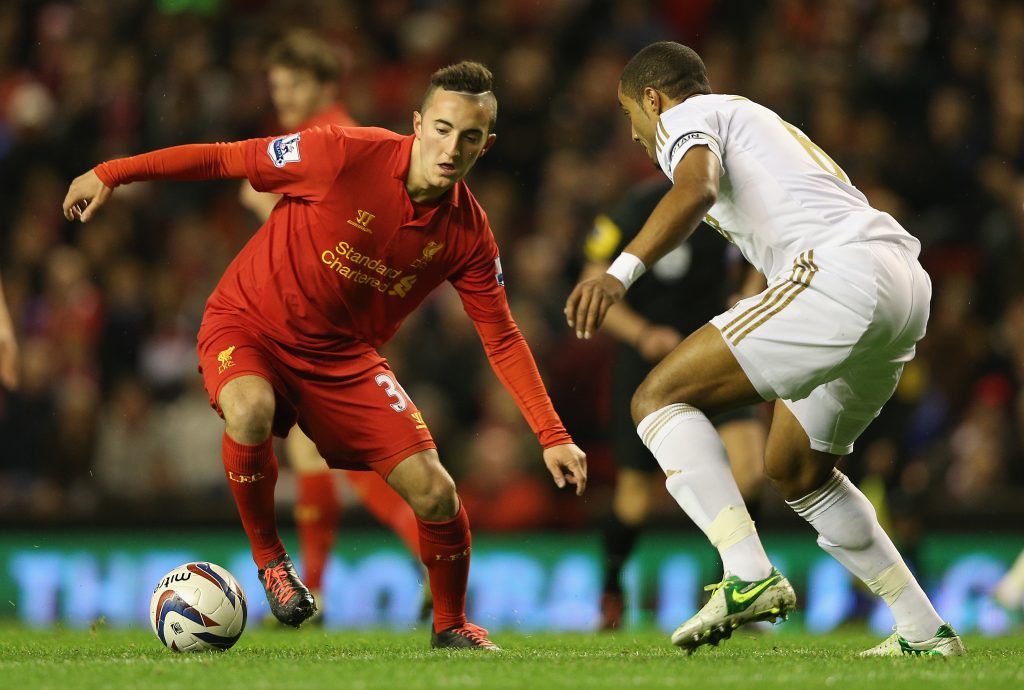 LIVERPOOL, ENGLAND - OCTOBER 31: Samed Yesil of Liverpool competes with Ashley Williams of Swansea City during the Capital One Cup Fourth Round match between Liverpool and Swansea City at Anfield on October 31, 2012 in Liverpool, England. (Photo by Clive Brunskill/Getty Images)