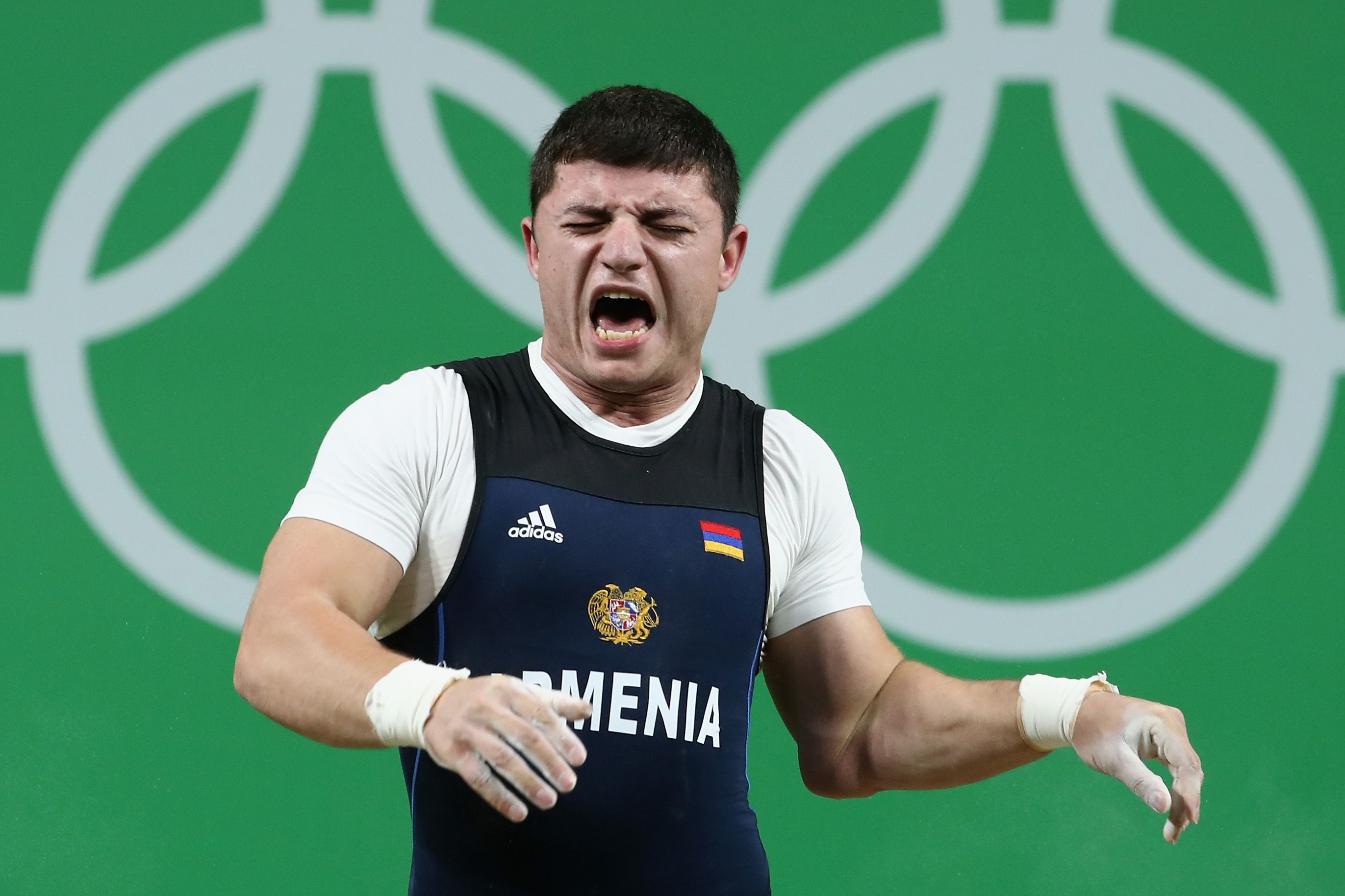 RIO DE JANEIRO, BRAZIL - AUGUST 10: Andranik Karapetyan of Armenia reacts to an injury during the Men's 77kg Group A weightlifting contest on Day 5 of the Rio 2016 Olympic Games at Riocentro - Pavilion 2 on August 10, 2016 in Rio de Janeiro, Brazil. (Photo by Julian Finney/Getty Images)