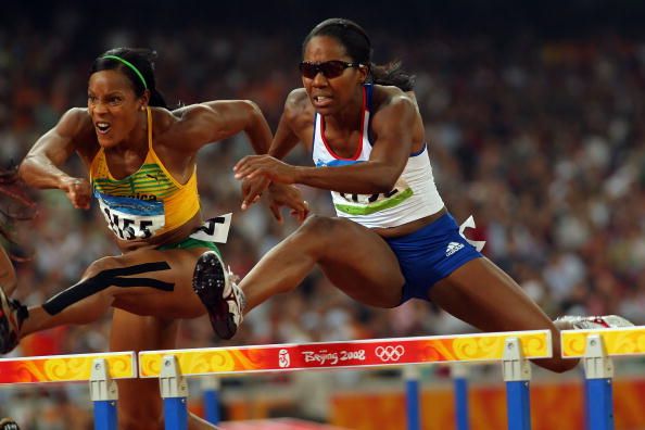 BEIJING - AUGUST 18: (L-R) Bridgitte Foster-Hylton of Jamaica and Sarah Claxton of Great Britain compete in the Women's 100m Hurdles Semi Final at the National Stadium on Day 10 of the Beijing 2008 Olympic Games on August 18, 2008 in Beijing, China. (Photo by Stu Forster/Getty Images)