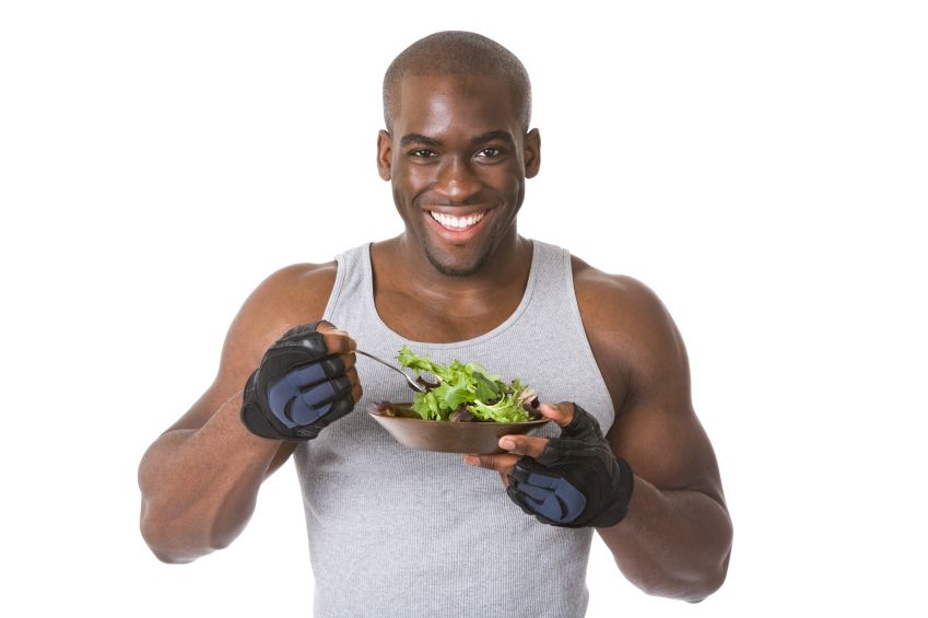 Bodybuilder eating a bowl of salad