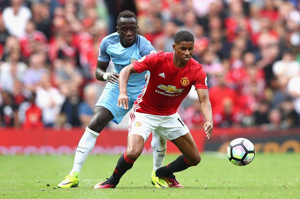 MANCHESTER, ENGLAND - SEPTEMBER 10: Marcus Rashford of Manchester United is challenged by Bacary Sagna of Manchester City during the Premier League match between Manchester United and Manchester City at Old Trafford on September 10, 2016 in Manchester, England. (Photo by Clive Brunskill/Getty Images)