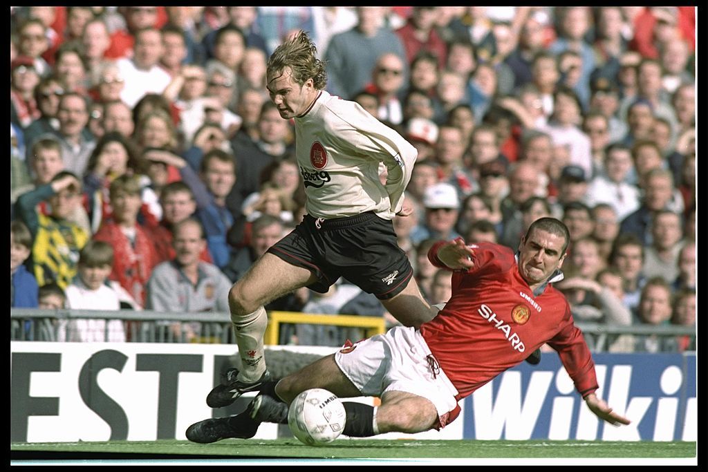 12 Oct 1996: Jason McAteer of Liverpool (left) is brought down by Eric Cantona of Manchester United during the FA Carling Premier league match between Manchester United and Liverpool at Old Trafford in Manchester. Manchester United went onto win the match by 1-0. Mandatory Credit: Clive Brunskill/Allsport