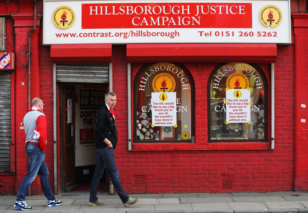 LIVERPOOL, UNITED KINGDOM - MAY 05: Fans walk past a Hillsborough Justice Campaign office prior to the UEFA Europa League semi final second leg match between Liverpool and Villarreal CF at Anfield on May 5, 2016 in Liverpool, England. (Photo by Richard Heathcote/Getty Images)