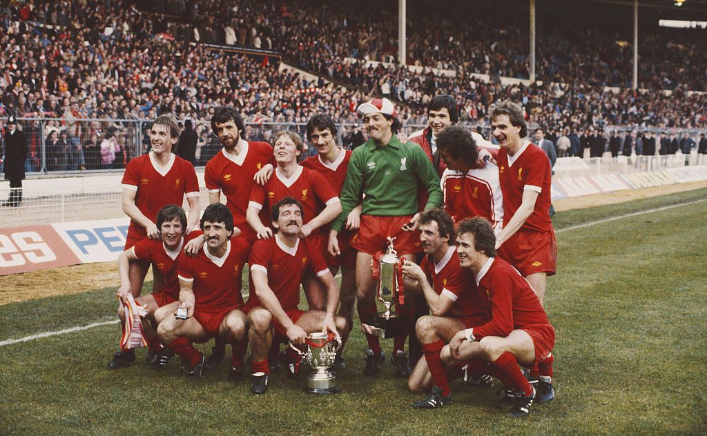 LONDON, UNITED KINGDOM - MARCH 13: The victorious Liverpool team pose after their 3-1 victory over Tottenham Hotspur to win the 1982 Milk Cup Final at Wembley Stadium on March 13, 1982 in London, England, back row from left to right, Kenny Dalglish, Mark Lawrenson, Sammy Lee, Ian Rush, Bruce Grobbelaar, Alan Hansen, Terry McDermott and Phil Thompson, front row, Ronnie Whelan, David Johnson, Graeme Souness, Alan Kennedy and Phil Neal. (Photo by Tony Duffy/Allsport/Getty Images)