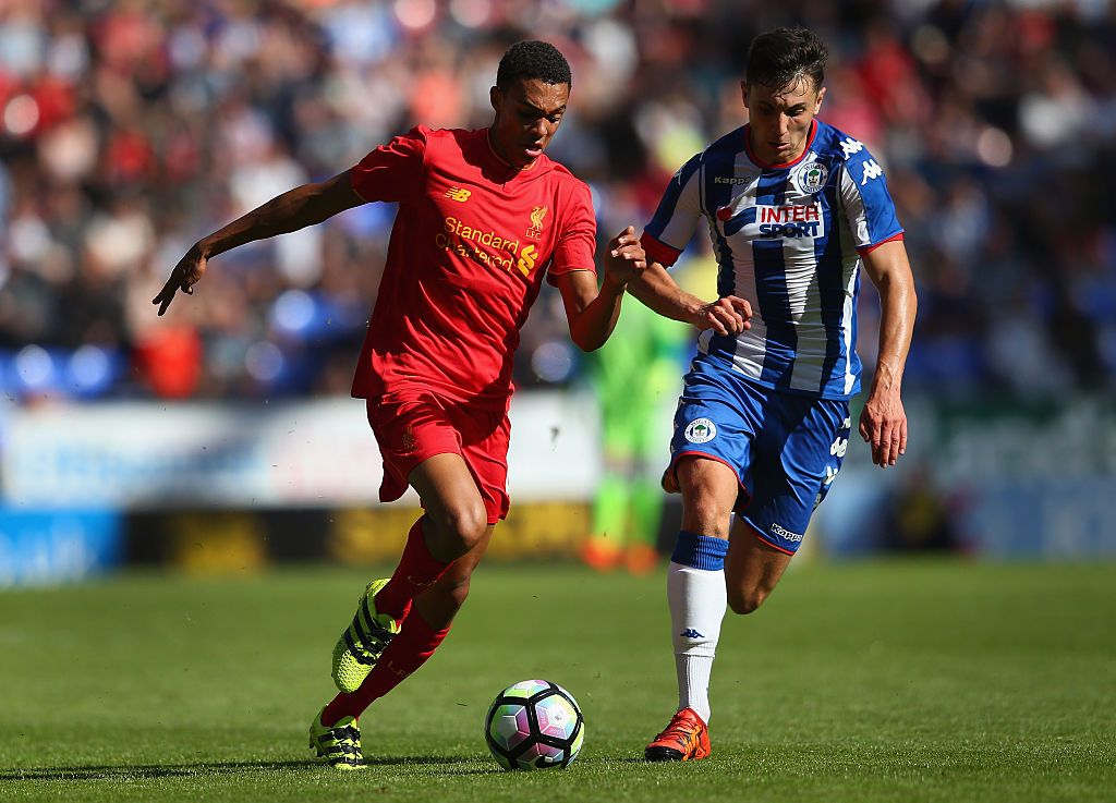 WIGAN, ENGLAND - JULY 17: Jordan Flores of Wigan Athletic and Trent Alexander-Arnold of Liverpool compete for the ball during a pre-season friendly between Wigan Athletic and Liverpool at JJB Stadium on July 17, 2016 in Wigan, England. (Photo by Alex Livesey/Getty Images)