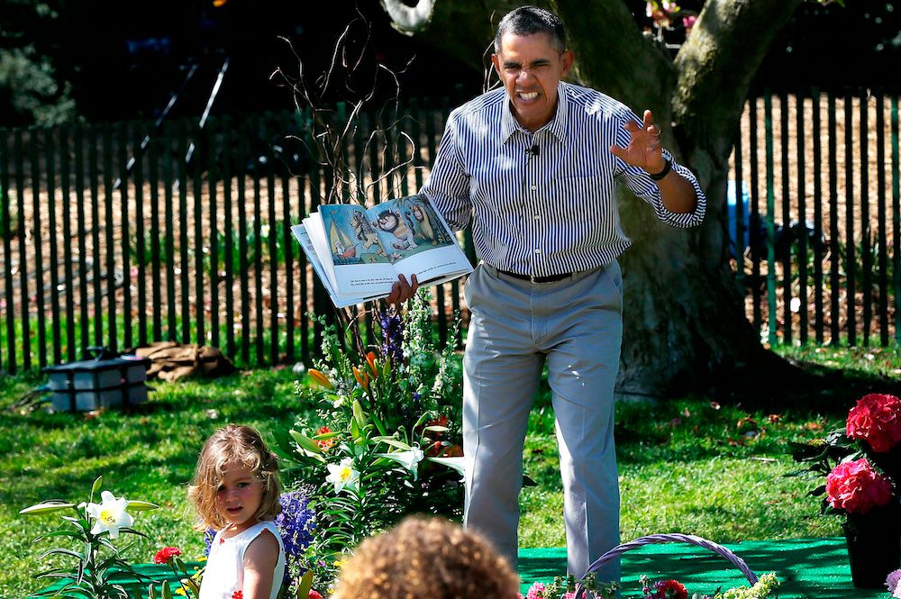WASHINGTON, DC - APRIL 21: U.S. President Barack Obama read to children from the book "Where the Wild Things Are" during the annual White House Easter Egg Roll on the South Lawn April 21, 2014 in Washington, DC. President Obama and the first lady hosted thousands of children for the annual White House event dating back to 1876 that features live music, sports courts, cooking stations, storytelling, as well as the Easter egg roll this year. (Photo by Win McNamee/Getty Images)