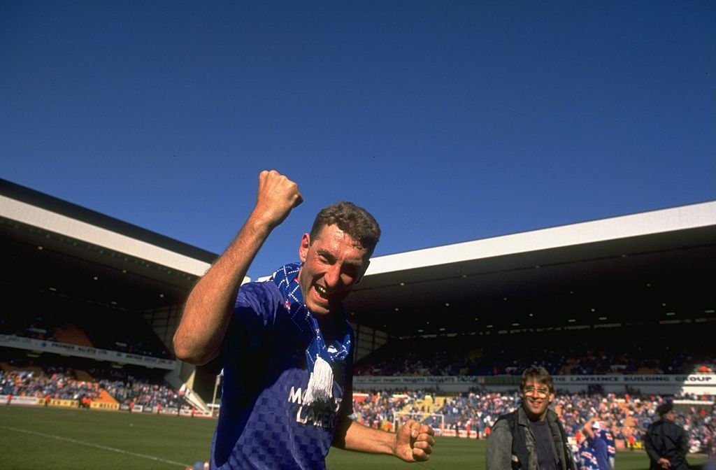 Terry Butcher of Rangers salutes victoriously after the Scottish Premier League match