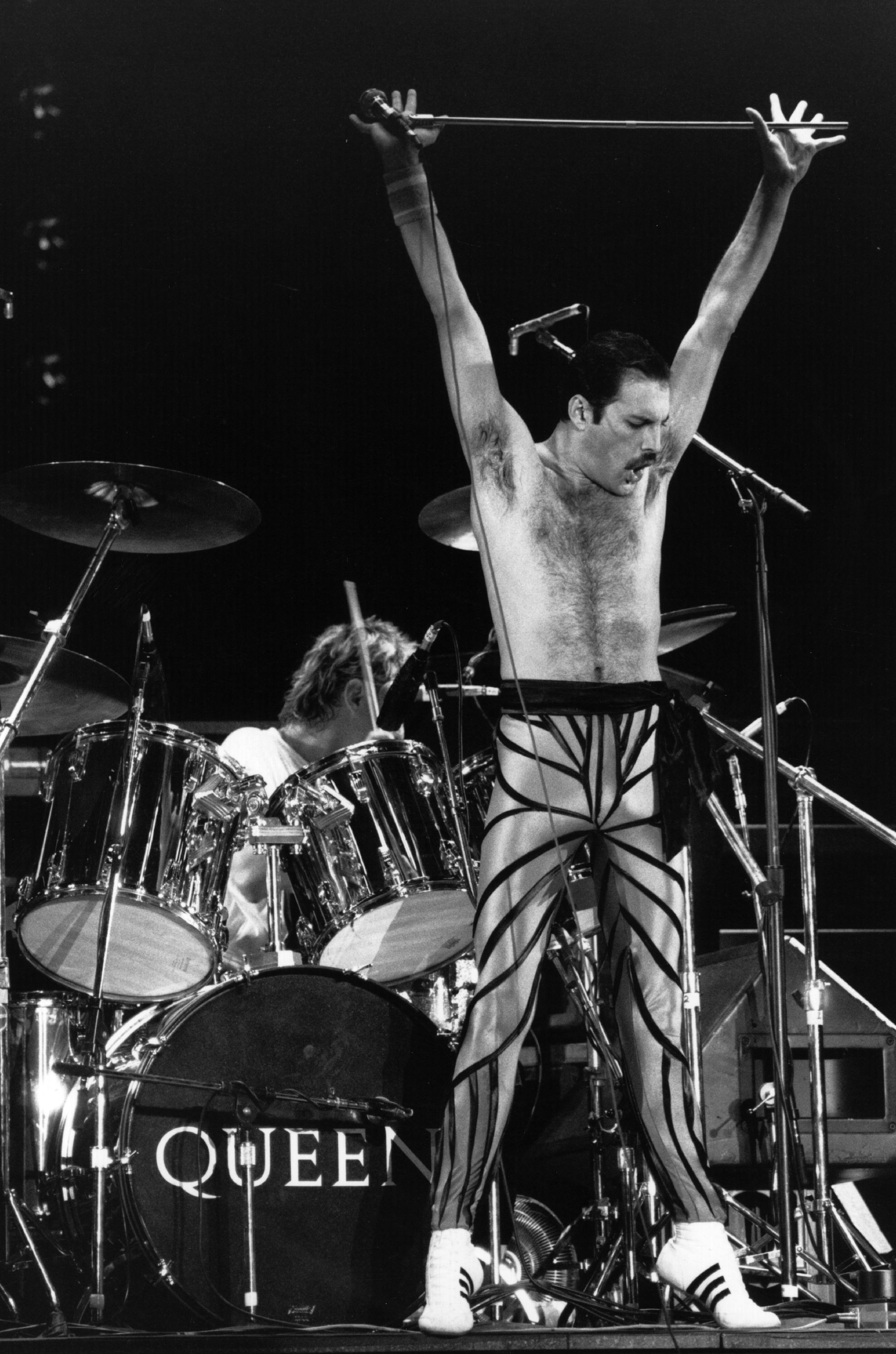 British stadium rock group Queen on stage, with lead singer Freddie Mercury (Frederick Bulsara, 1946 - 1991) in the foreground. Original Publication: People Disc - HU0462 (Photo by Express Newspapers/Getty Images)