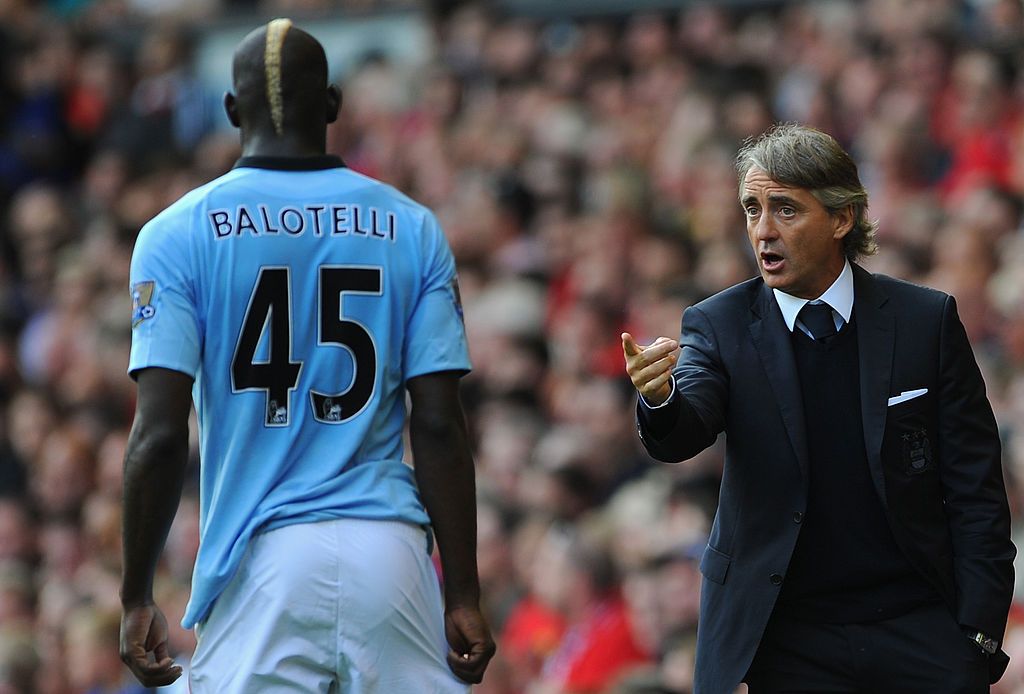 LIVERPOOL, ENGLAND - AUGUST 26: Manchester City Manager Roberto Mancini gives instructions to Mario Balotelli of Manchester City during the Barclays Premier League match between Liverpool and Manchester City at Anfield on August 26, 2012 in Liverpool, England. (Photo by Michael Regan/Getty Images)