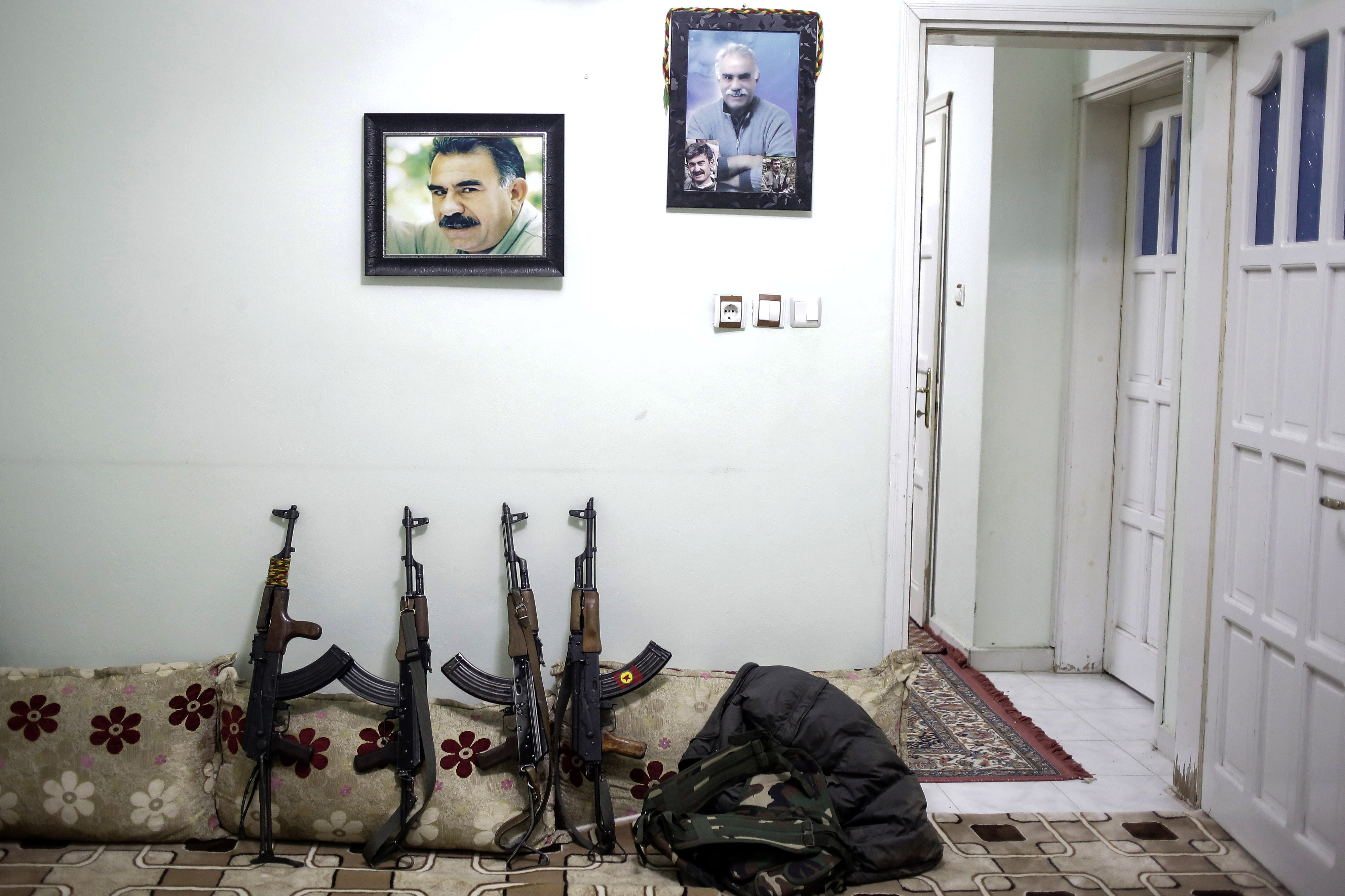 AK-47's of armed group Patriotic Revolutionary Youth Movement (YDG-H), a youth division of the Kurdistan Workers' Party, PKK, stand under jailed Kurdish rebel leader Abdullah Ocalan's pictures in a house in southeastern Turkish city of Nusaybin on February 25, 2016, Turkey. Since mid-December, the Turkish security forces placed to several predominantly Kurdish cities in Turkey under 24-hour martial law and curfew on the premise of restoring public order. (Photo by Cagdas Erdogan/Getty Images)