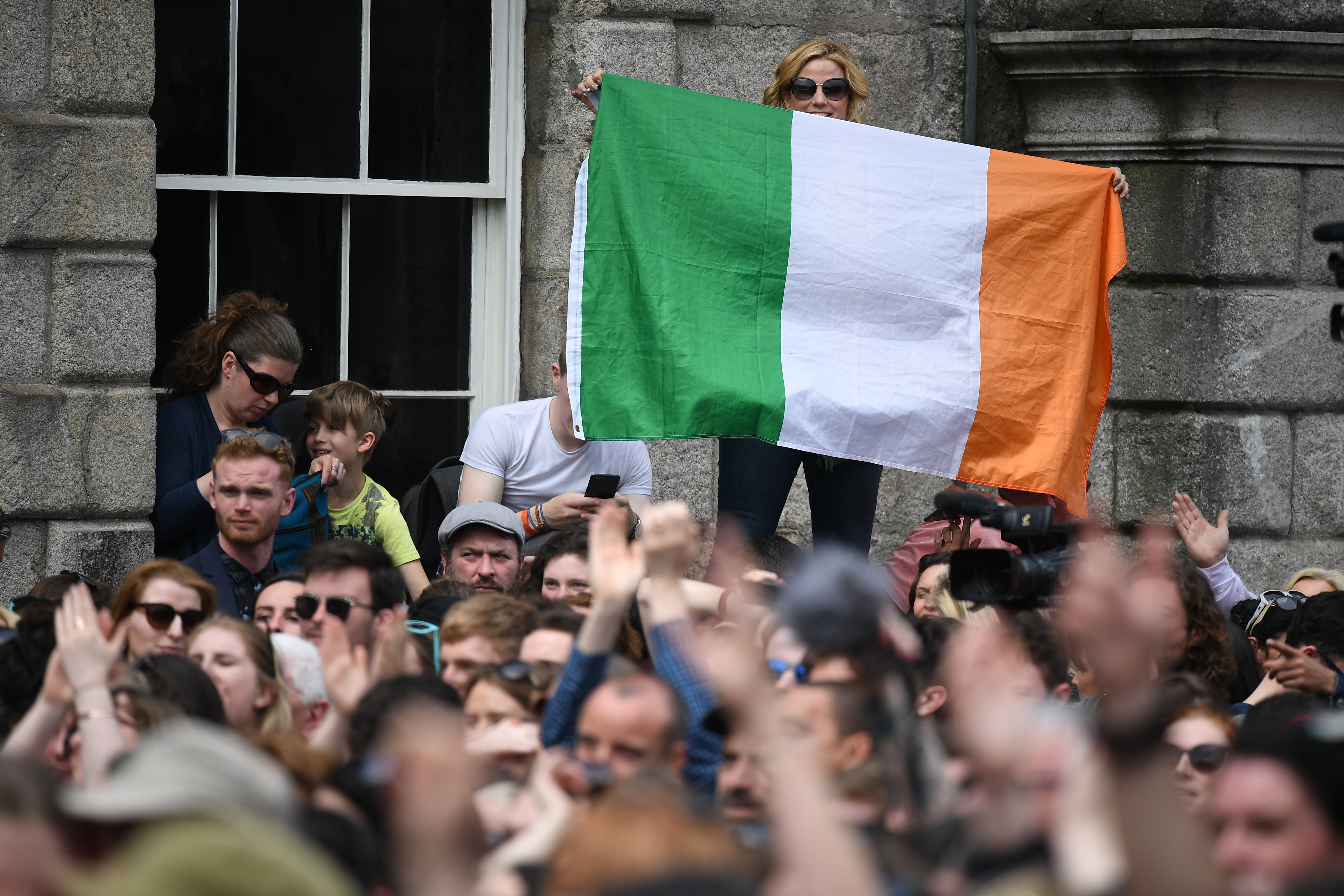 A woman holds an Irish flag aloft at Dublin Castle as she waits for the result of the referendum on the Eighth Amendment of the constitution