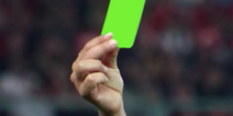 Referee brandishes first ever green card in a football match