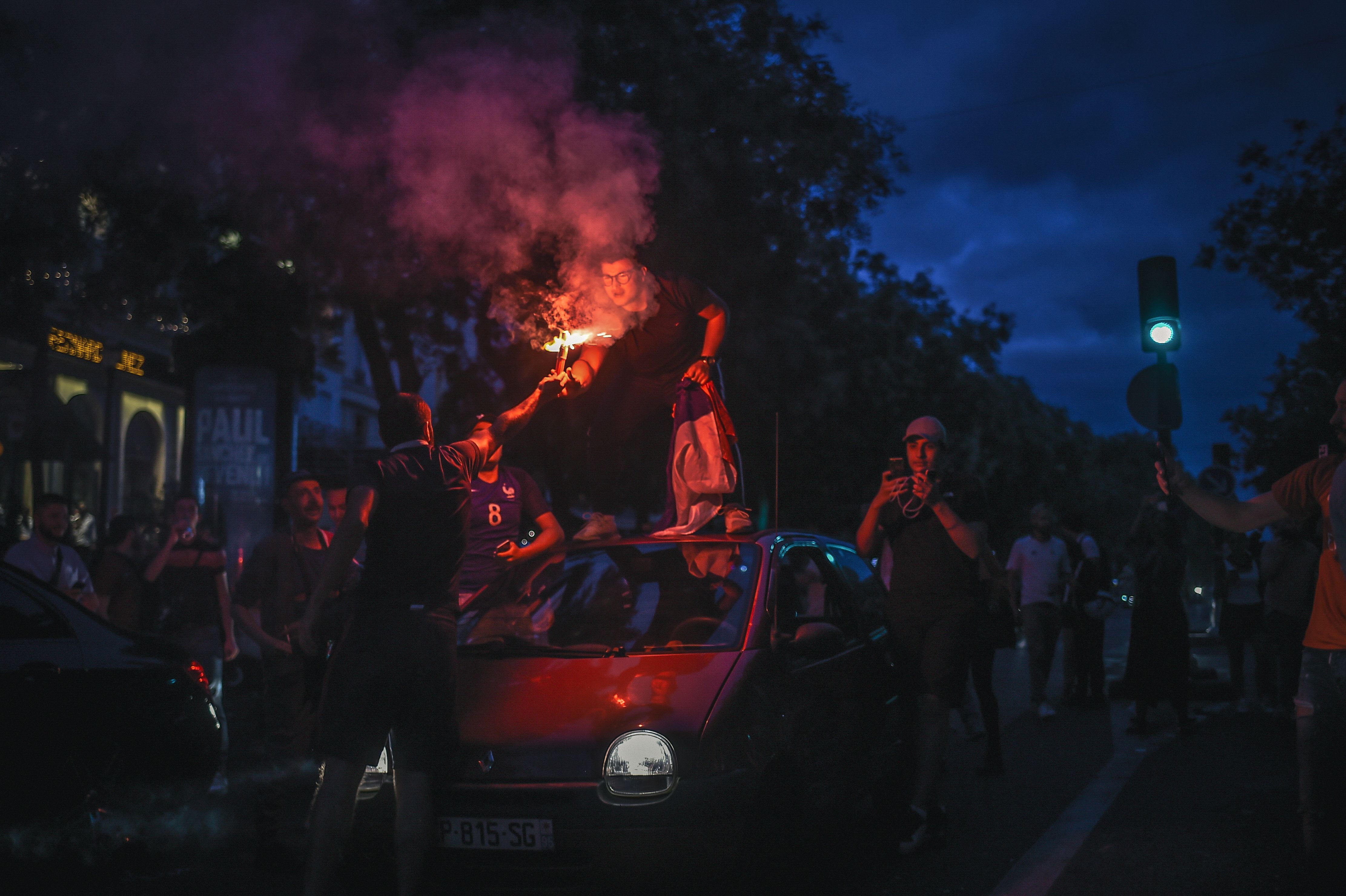 People celebrate France's victory on the Champs Elysees in Paris on July 10, 2018, after the final whistle of the Russia 2018 World Cup semi-final football match between France and Belgium. (Photo by Lucas BARIOULET / AFP) (Photo credit should read LUCAS BARIOULET/AFP/Getty Images)