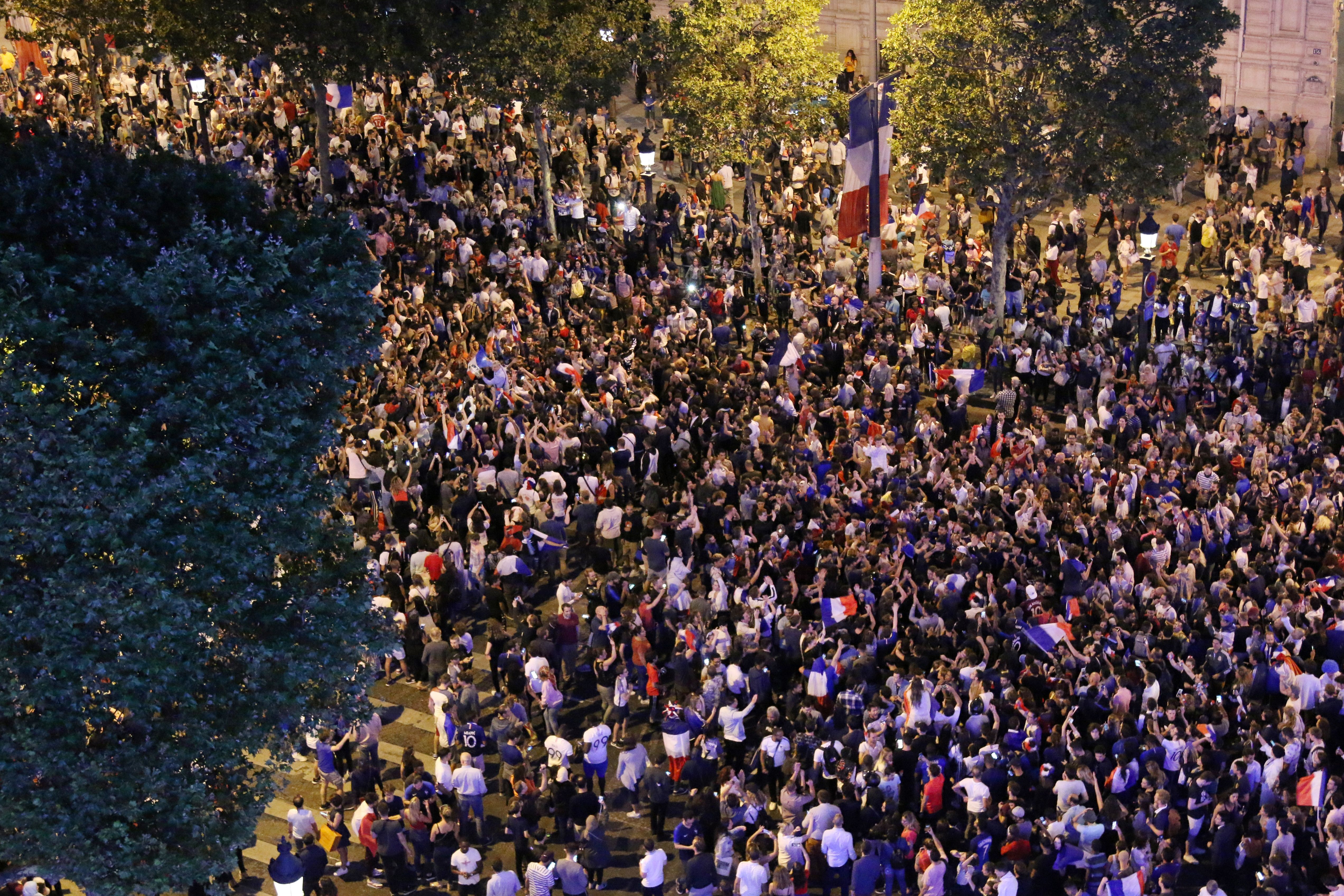 TOPSHOT - People celebrate France's victory on the Champs Elysee in Paris on July 10, 2018, after the final whistle of the Russia 2018 World Cup semi-final football match between France and Belgium. (Photo by ZAKARIA ABDELKAFI / AFP) (Photo credit should read ZAKARIA ABDELKAFI/AFP/Getty Images)