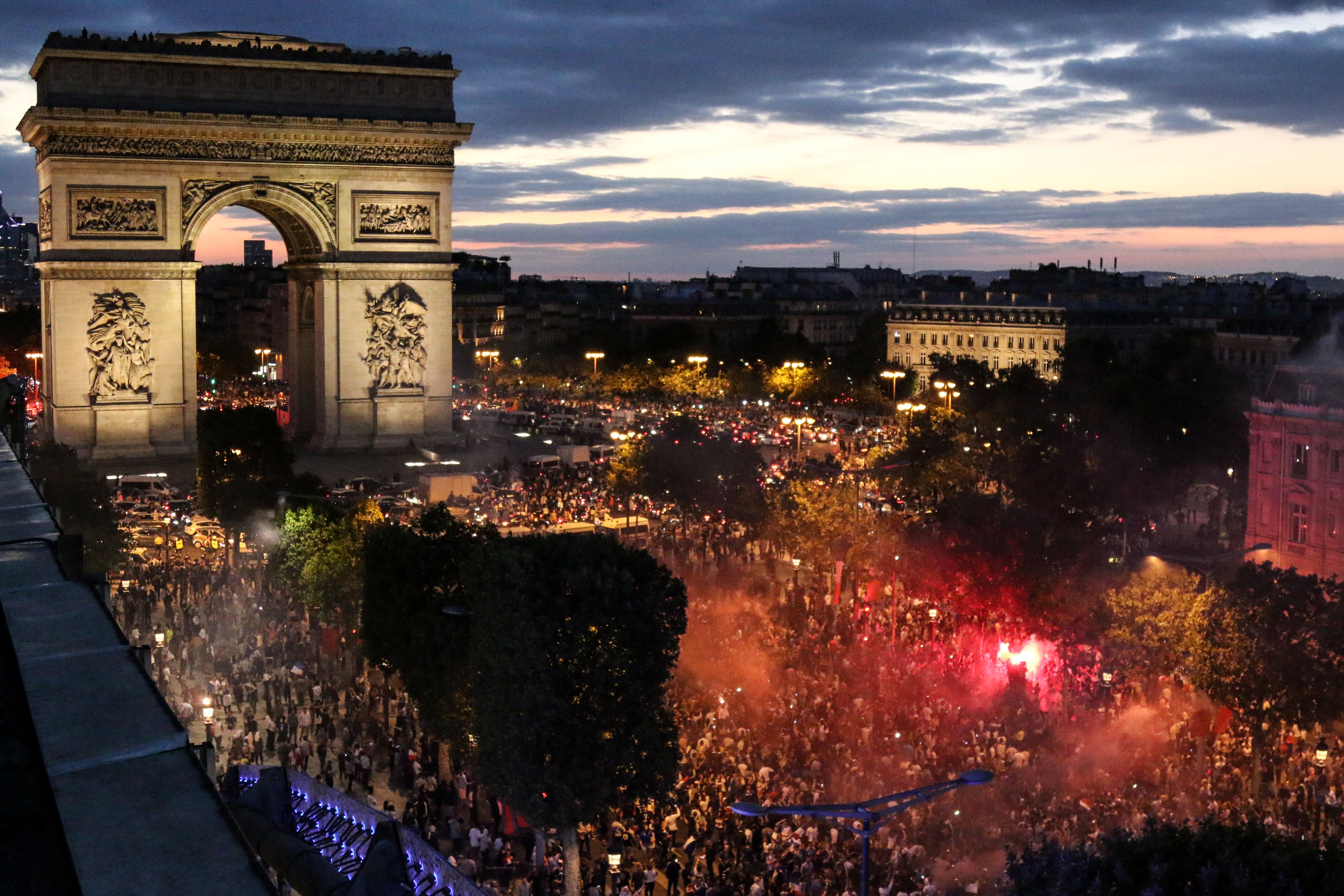 TOPSHOT - People celebrate France's victory at The Arc de Triomphe on the Champs Elysee in Paris on July 10, 2018, after the final whistle of the Russia 2018 World Cup semi-final football match between France and Belgium. (Photo by ZAKARIA ABDELKAFI / AFP) (Photo credit should read ZAKARIA ABDELKAFI/AFP/Getty Images)