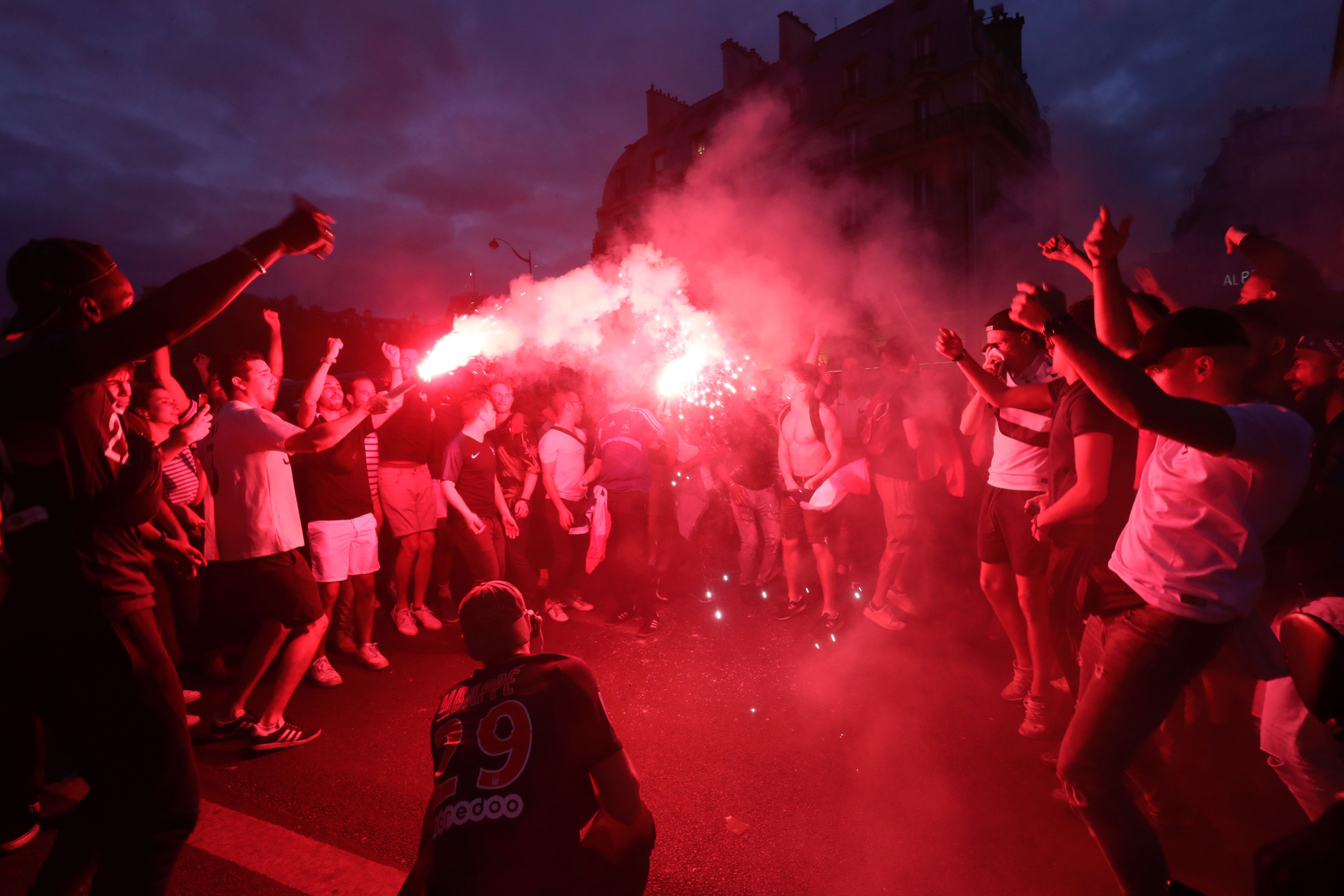TOPSHOT - People celebrate France's victory in central Paris on July 10, 2018 after the final whistle of the Russia 2018 World Cup semi-final football match between France and Belgium. (Photo by Thomas SAMSON / AFP) (Photo credit should read THOMAS SAMSON/AFP/Getty Images)