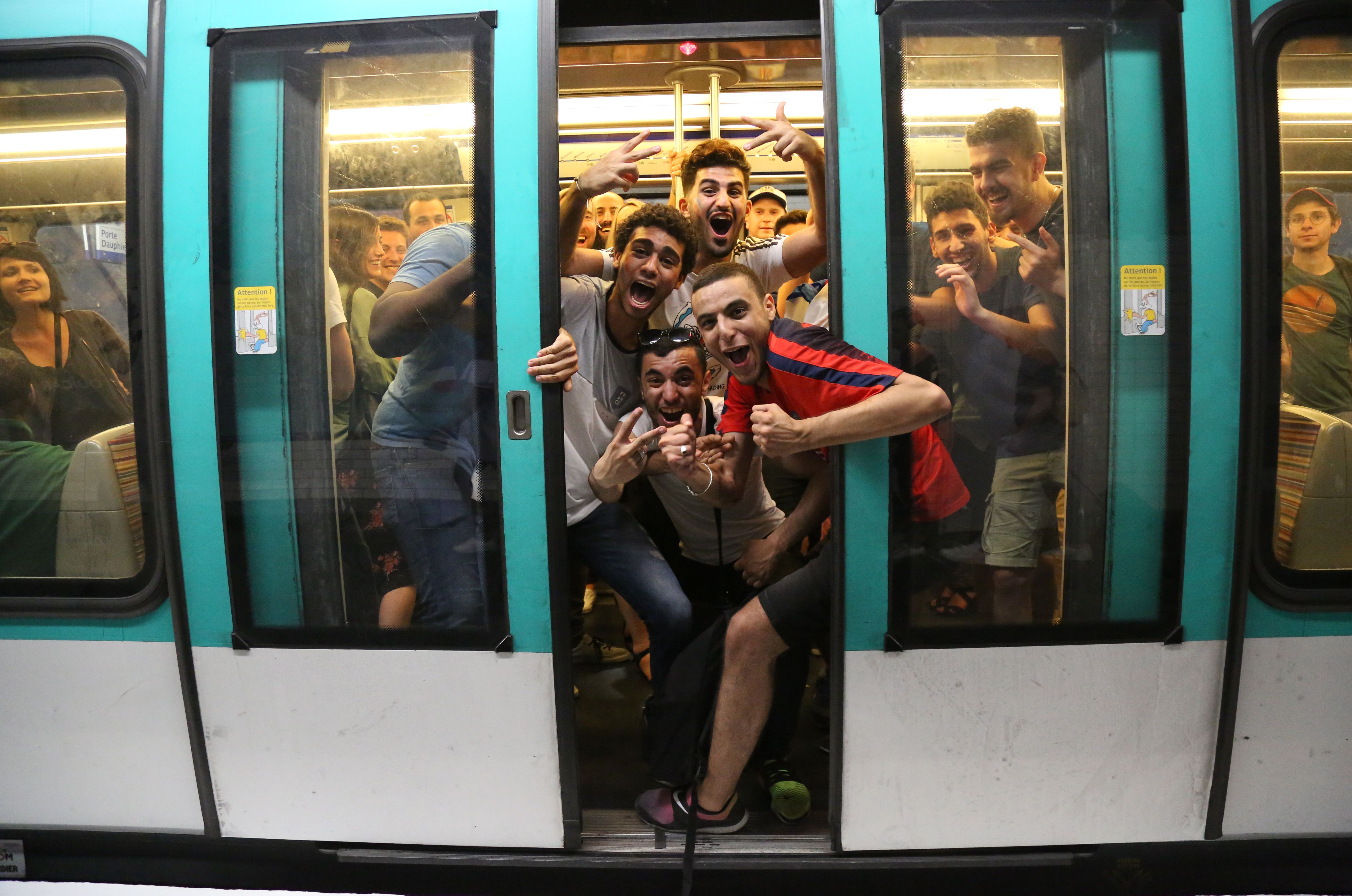 TOPSHOT - People celebrate France's 1-0 victory on board the Metro in Paris on July 10, 2018, after the final whistle of the Russia 2018 World Cup semi-final football match between France and Belgium. (Photo by Zakaria ABDELKAFI / AFP) (Photo credit should read ZAKARIA ABDELKAFI/AFP/Getty Images)
