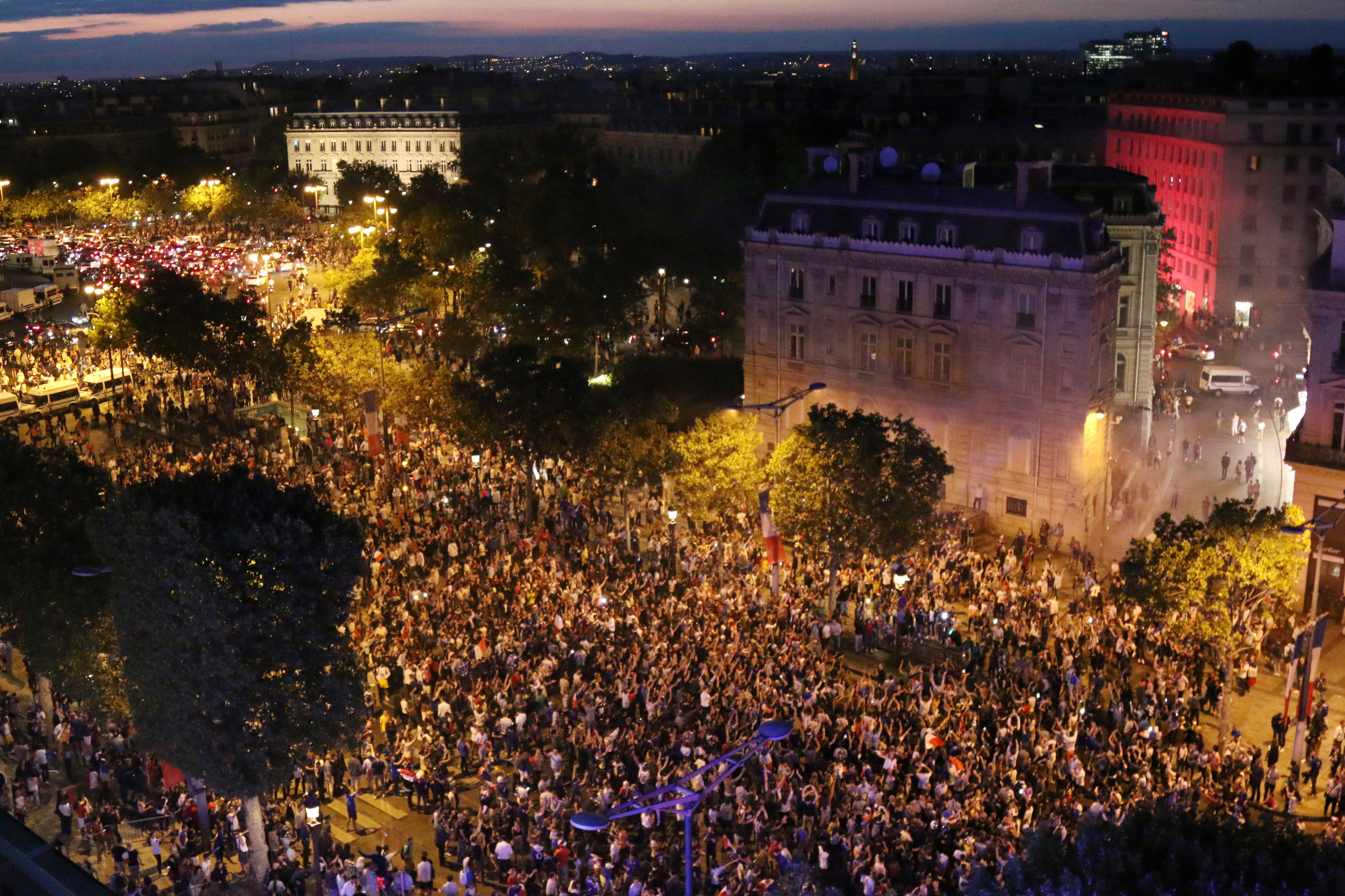 People celebrate France's victory on the Champs Elysee in Paris on July 10, 2018, after the final whistle of the Russia 2018 World Cup semi-final football match between France and Belgium. (Photo by ZAKARIA ABDELKAFI / AFP) (Photo credit should read ZAKARIA ABDELKAFI/AFP/Getty Images)