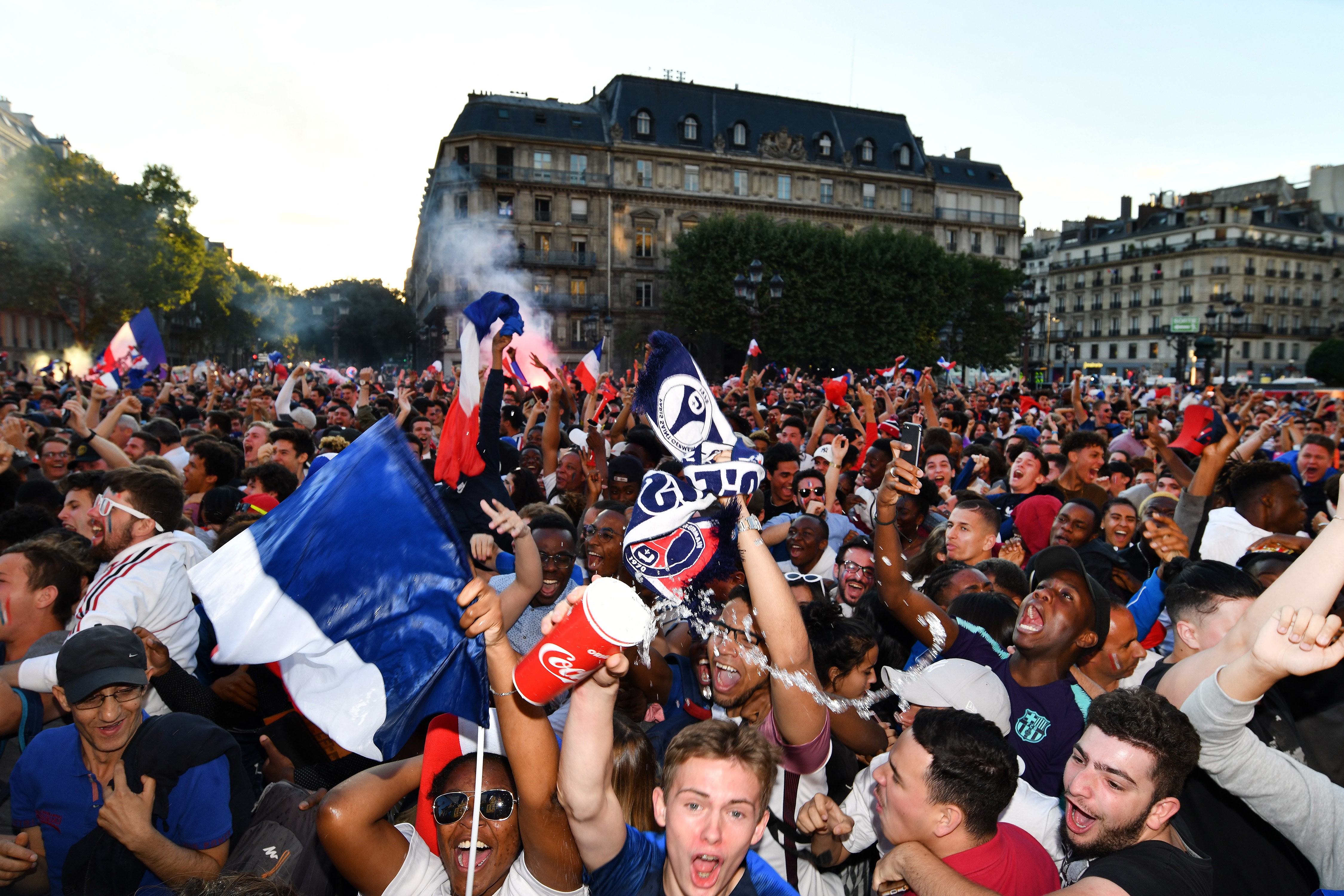 PARIS, FRANCE - JULY 10: Supporters of France football national team celebrate their team's victory against Belgium of the semifinal match in the FIFA 2018 World Cup in front of the Hotel de Ville in Paris, France on July 10, 2018. (Photo by Mustafa Yalcin/Anadolu Agency/Getty Images)