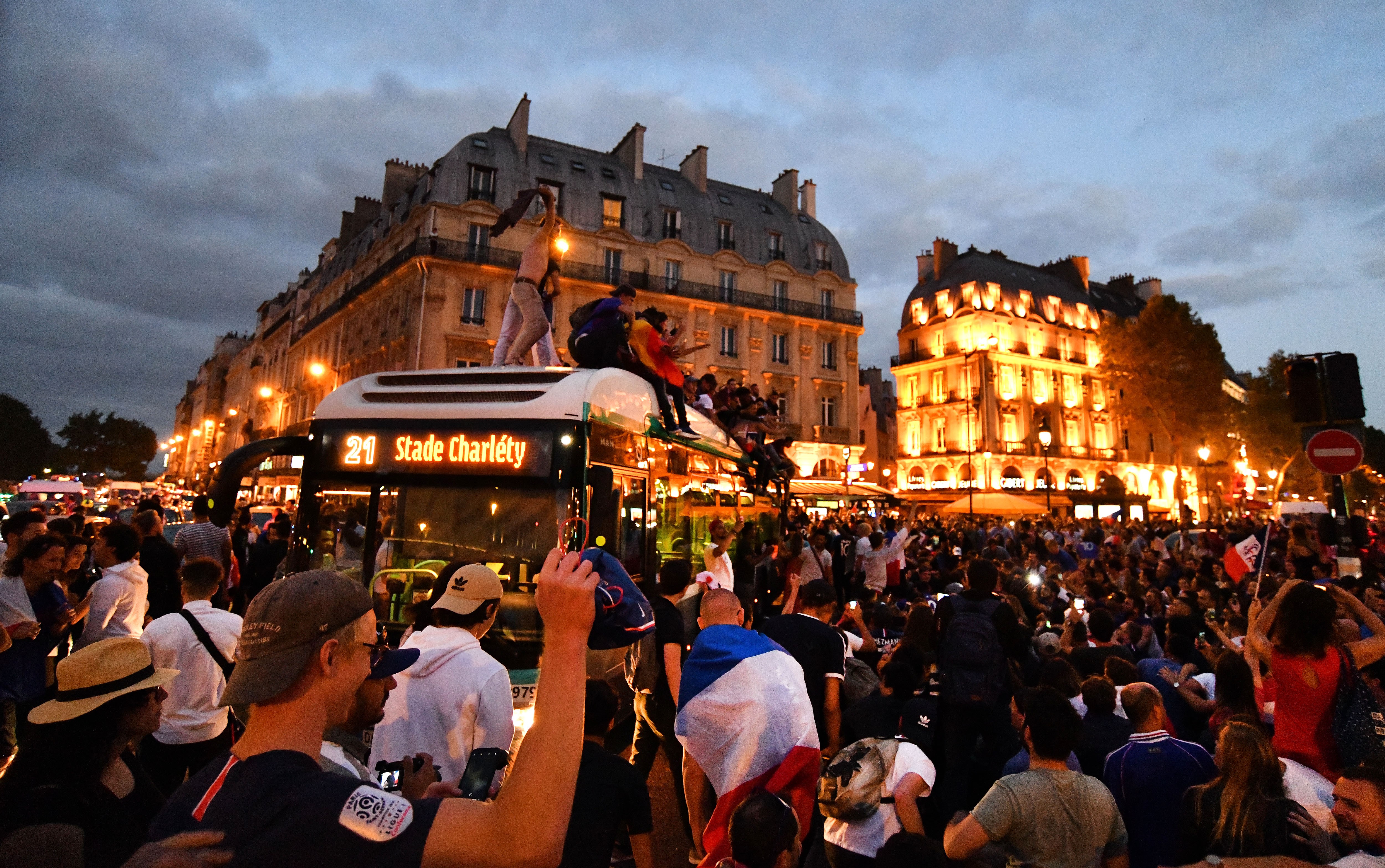 PARIS, FRANCE - JULY 10: Supporters of France football national team celebrate their team's victory against Belgium of the semifinal match in the FIFA 2018 World Cup in front of the Hotel de Ville in Paris, France on July 10, 2018. (Photo by Mustafa Yalcin/Anadolu Agency/Getty Images)