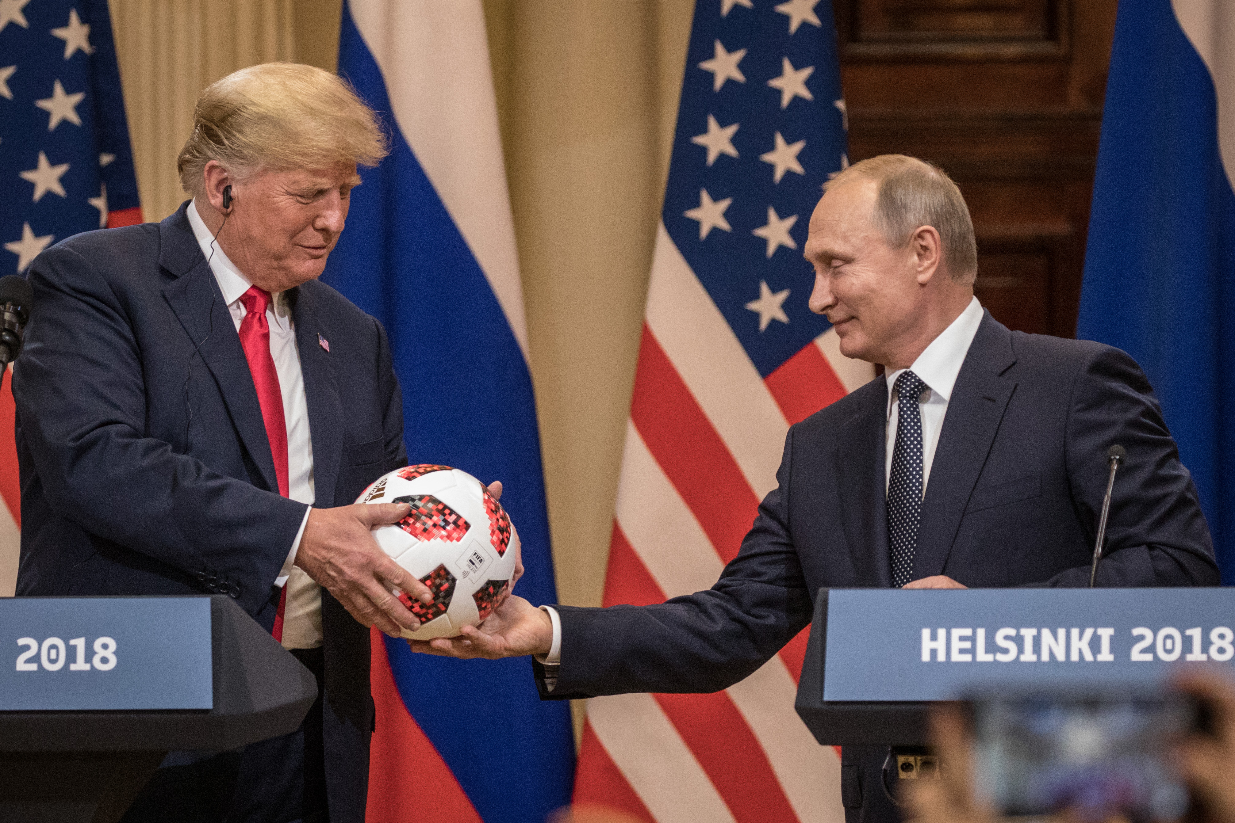 HELSINKI, FINLAND - JULY 16: Russian President Vladimir Putin hands U.S. President Donald Trump (L) a World Cup football during a joint press conference after their summit on July 16, 2018 in Helsinki, Finland. The two leaders met one-on-one and discussed a range of issues including the 2016 U.S E/Getty Images)