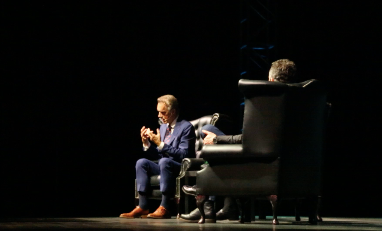 Jordan Peterson conjures an argument with his hands at London's O2 Arena