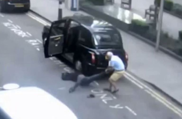 A Black Cab taxi driver pulls his unconscious passenger from the car and into the road
