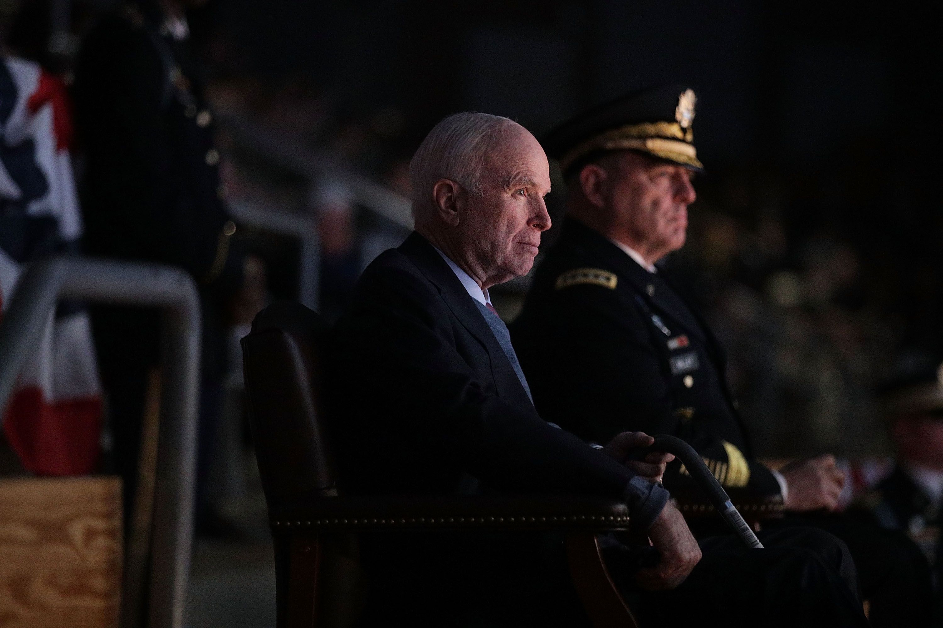 ARLINGTON, VA - NOVEMBER 14: U.S. Army Chief of Staff Gen. Mark A. Milley (R) and Sen. John McCain (R-AZ) (L) watch a special Twilight Tattoo performance November 14, 2017 at Fort Myer in Arlington, Virginia. Sen. McCain was honored with the Outstanding Civilian Service Medal for over 63 years of dedicated service to the nation and the U.S. Navy. (Photo by Alex Wong/Getty Images)