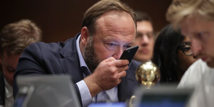 WASHINGTON, DC - SEPTEMBER 5: Alex Jones of InfoWars speaks into his phone during a Senate Intelligence Committee hearing concerning foreign influence operations' use of social media platforms, on Capitol Hill, September 5, 2018 in Washington, DC. Twitter CEO Jack Dorsey and Facebook chief operating officer Sheryl Sandberg faced questions about how foreign operatives use their platforms in attempts to influence and manipulate public opinion. (Photo by Drew Angerer/Getty Images)