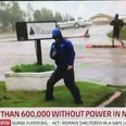 Weatherman called out for being ‘dramatic’ when men casually stroll past during Hurricane broadcast