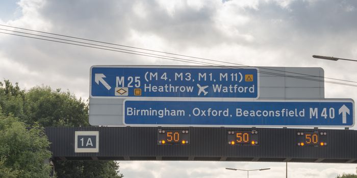 Sign on motorway in England exit to M25 , M40 straight ahead.