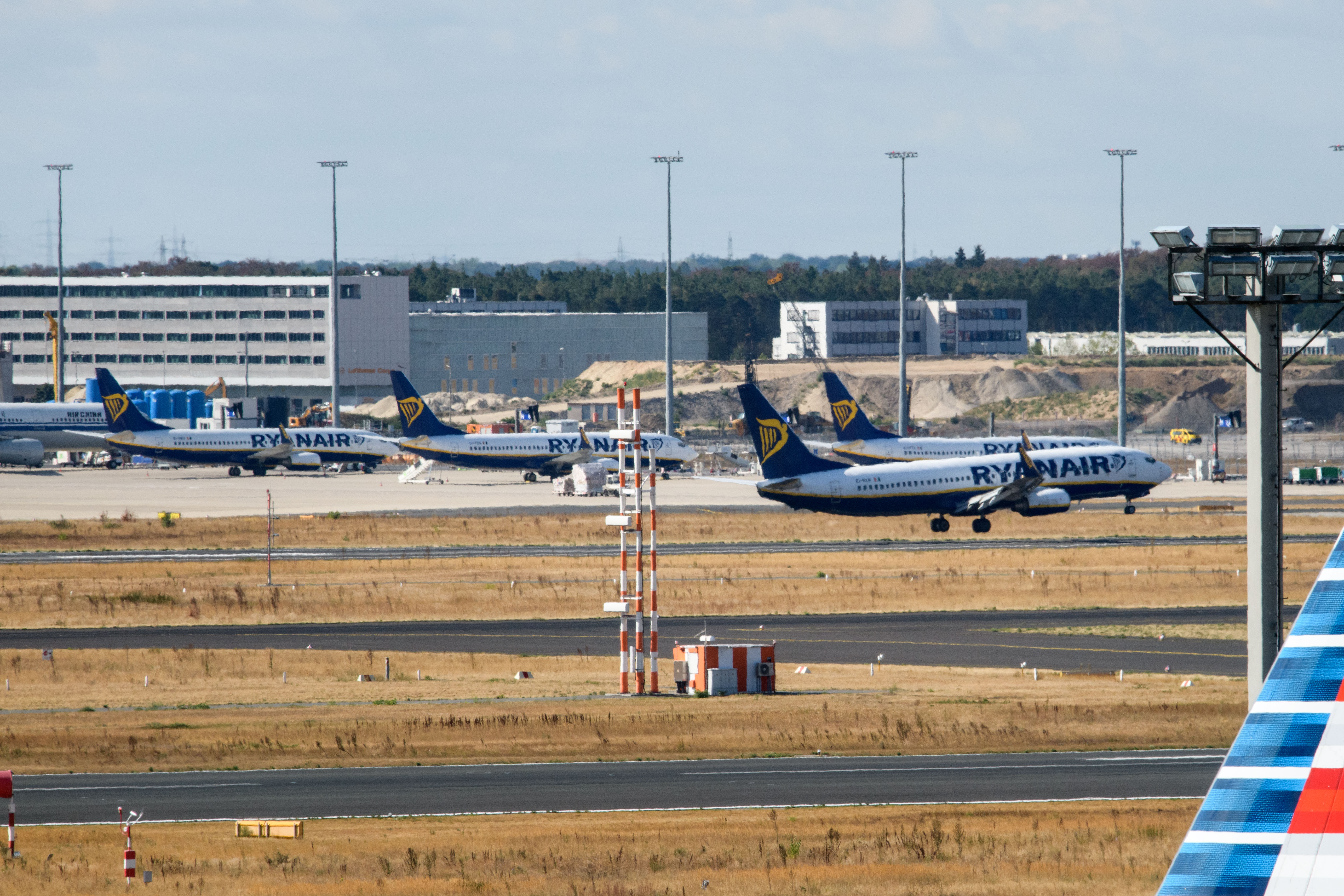 FRANKFURT AM MAIN, GERMANY - AUGUST 10: An airplane of discount airliner RyanAir lands during a 24-hour strike by the pilots while other stand at the Frankfurt Airport on August 10, 2018 in Frankfurt, Germany. RyanAir pilots in Germany, Ireland, Sweden, Belgium and Holland are taking part in the strike over demands for better pay and working conditions. (Photo by Thomas Lohnes/Getty Images)