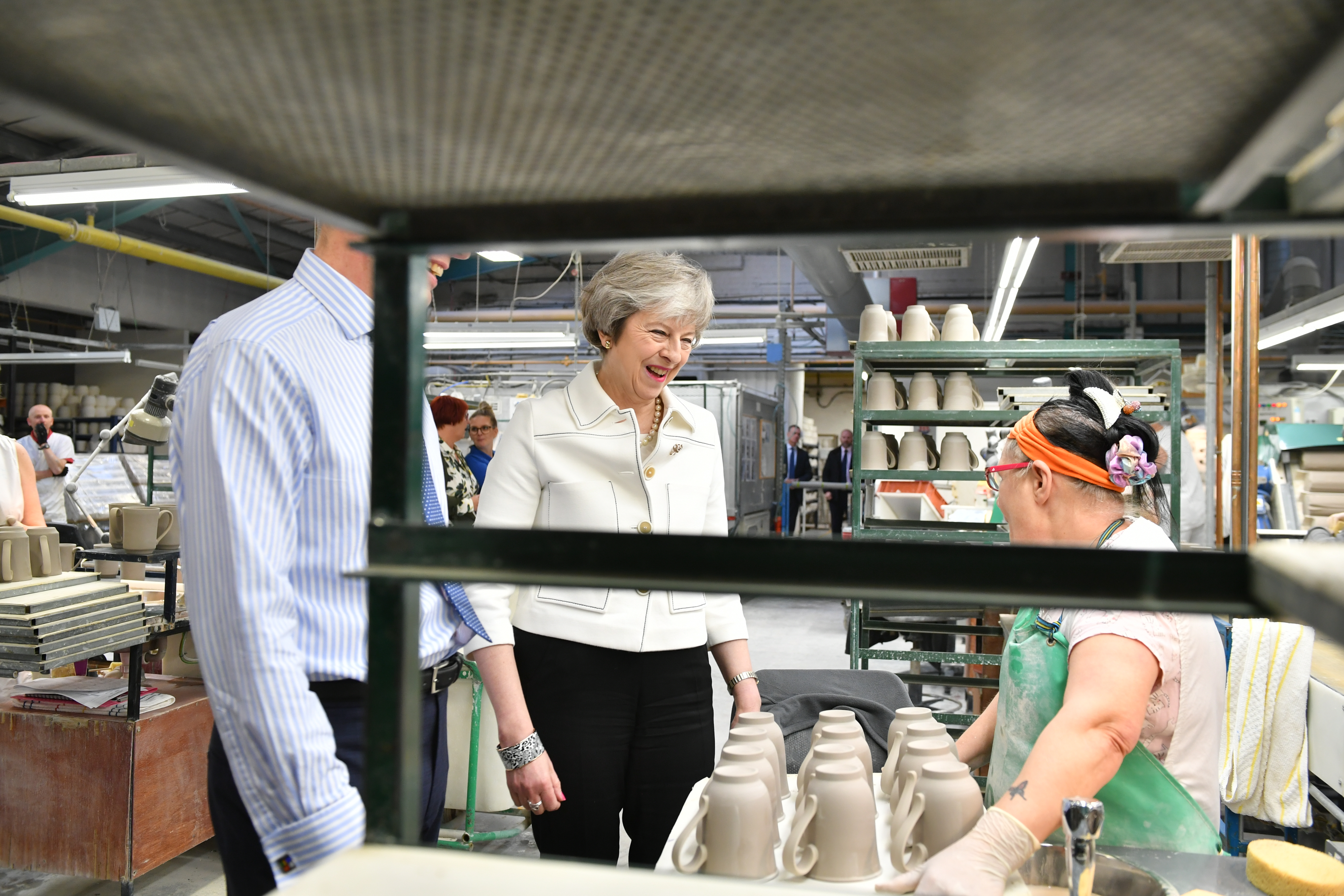 STOKE ON TRENT, ENGLAND - JANUARY 14: British Prime Minister Theresa May with production manager Rob Findler tours the Portmeirion factory on January 14, 2019 in Stoke on Trent, England. On the eve of the critical Commons vote on her plan to leave the EU, Ms May is urging MPs to consider the "consequences" of their actions in effecting the people's faith in Britain's democracy. (Photo by Ben Birchall - WPA Pool/Getty Images)