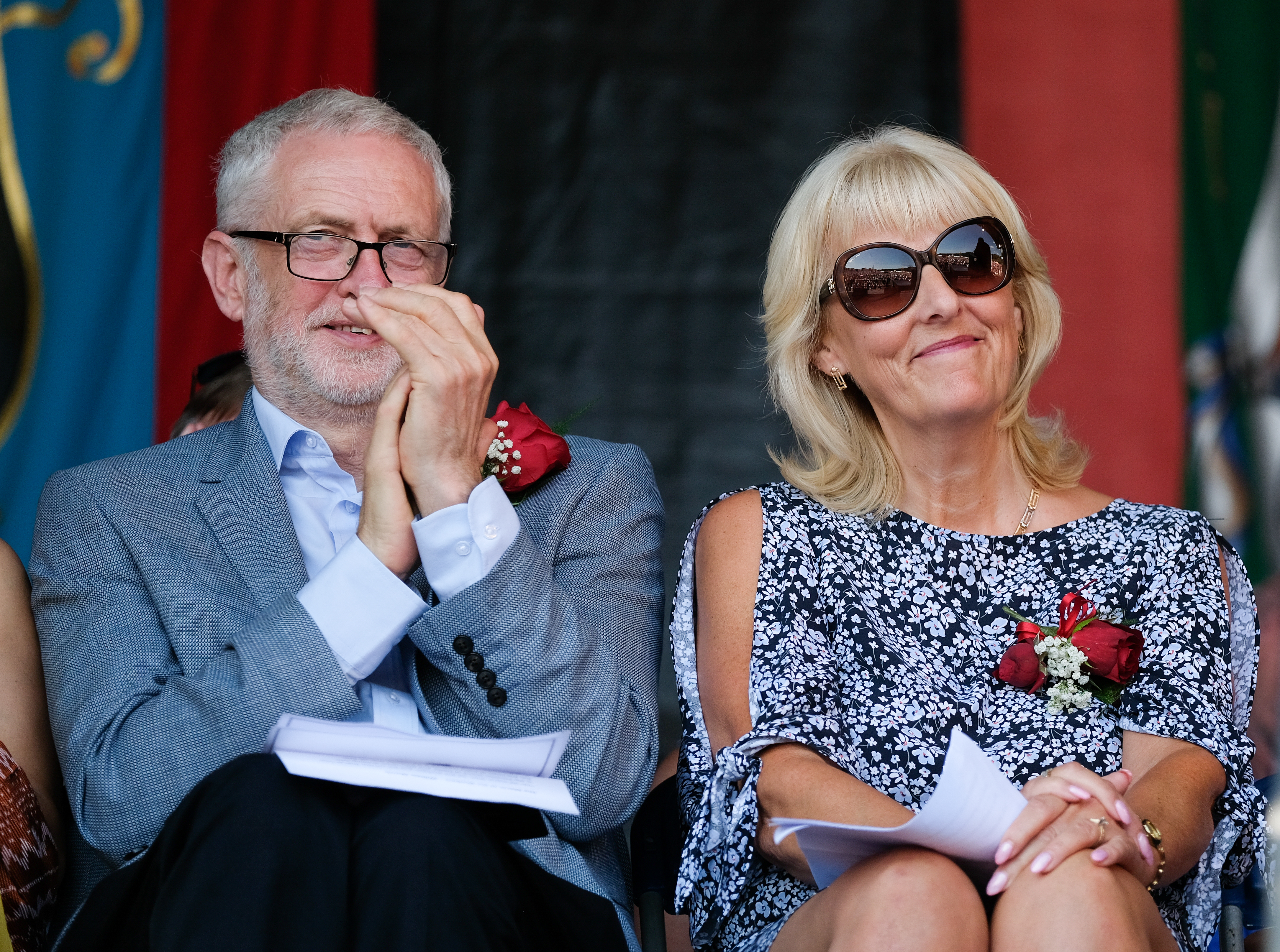 DURHAM, ENGLAND - JULY 14: Labour leader Jeremy Corbyn applauds as he sits with Labour General Secretary Jennie Formby and listens to speeches during the 134th Durham Miners' Gala on July 14, 2018 in Durham, England. Over two decades after the last pit closed in the Durham coalfield the Miners Gala or Big Meeting as it is known locally remains as popular as ever with over 200,000 people expected to attend this year. The gala forms part of the culture and heritage of the area and represents the communal values of the North East of England. The gala sees traditional colliery brass bands march through the city ahead of their respective pit banners before pausing to play outside the County Hotel building where union leaders, invited guests and dignitaries gather before then continuing to the racecourse area for a day of entertainment and speeches. Beginning in 1871 the gala is the biggest trade union event in Europe and is part of an annual celebration of socialism.  (Photo by Ian Forsyth/Getty Images)