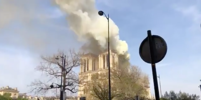 Smoke engulfs the spire of Notre Dame cathedral in Paris during a fire