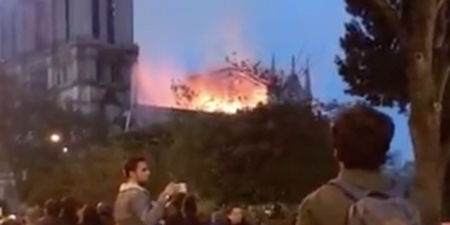 Watch Parisians sing at the feet of their burning Lady